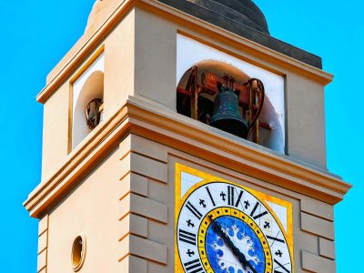 Clock tower of Church of Santo Stefano on Capri Island, Italy. Summer