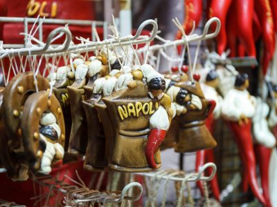 Naples, Italy - December 9, 2016: San Gregorio Armeno, a stall exposes for sale hand-made pendants, superstitious and good luck symbols, the Neapolitan culture.