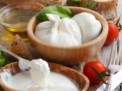 Italian cheese burrata with bread, vegetables  and herbs