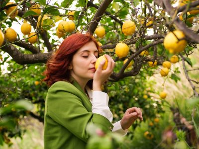 Girl smells yellow lemon
